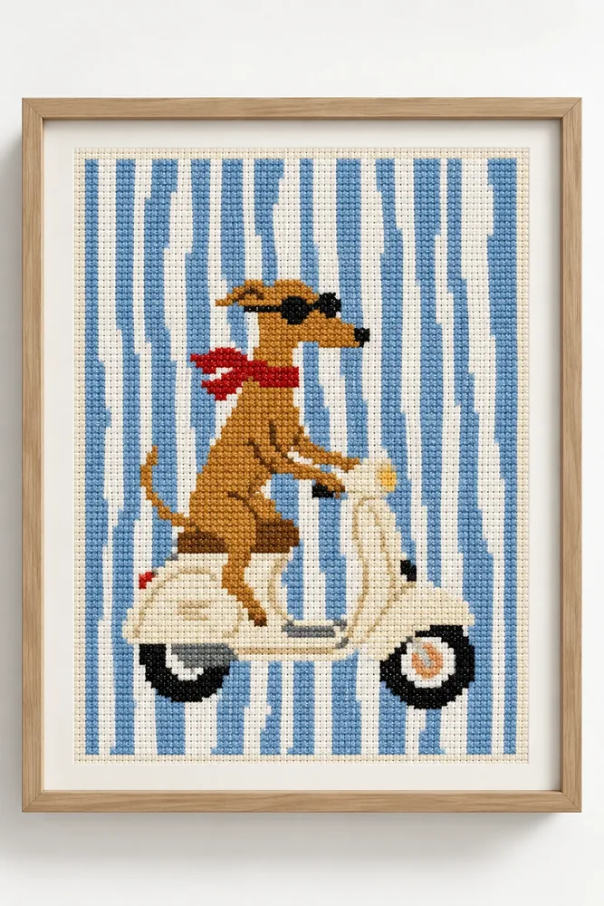 Quadro bordado em ponto cruz de um galgo de óculos escuros e lenço vermelho andando de Vespa sobre listras azuis